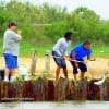 Fellow anglers netting Larkin's redfish