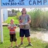 Dad and son Garry Smith with 8 yr old Curt from Lufkin TX show off there nice catch