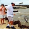 Fellow angler netting Elliott's speck