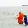 Neither wind or rain will dampen a grandpa's day out with his grandson