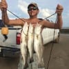 Rollover angler Steven Reed shows off his surf catch after wading with a T-28