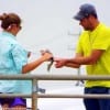 Tampa Florida couple measure this nice speck to be sure it's a keeper