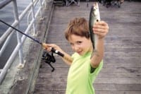 Young angler with his nice blue