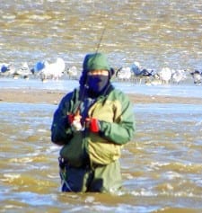 Braving chilly North winds this Rollover Bay wade-angler searches the wind whipped waters for flounder