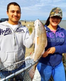 Fishing a live shrimp Juan Guzman of South Houston landed this nice slot red with the help of Ruby Trevino