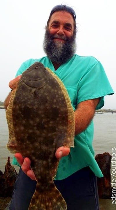 Conroe TX angler John Barnes hefts this really nice flounder caught on a soft plastic