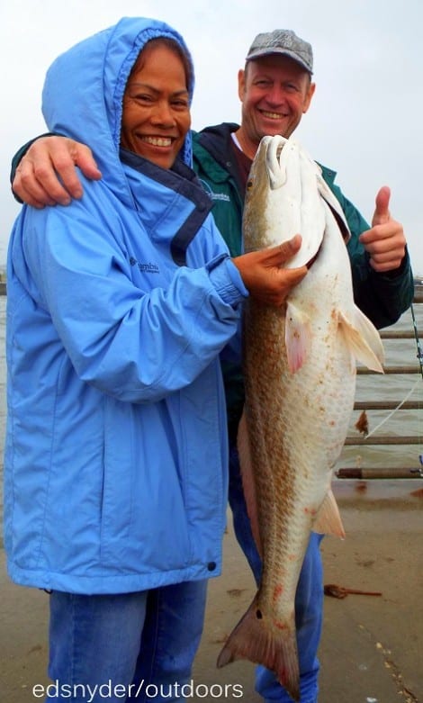 Conroe anglerette Noi Colby hefts her nice 37 inch tagger bull red she caught on shrimp