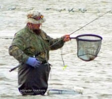 This wade angler braved the early morning chill to net this nice doormat flounder he took on a berkely gulp