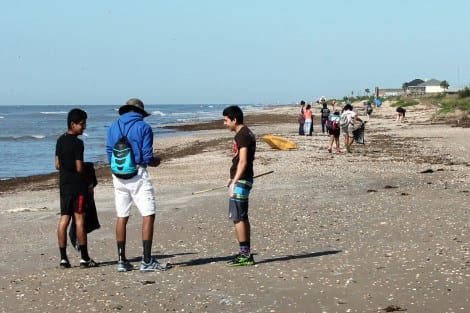 Thirty-three Liberty High students, representing the Interact Club and Leo Club service organizations, picking up trash near Rollover Pass.