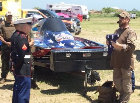 Ken Meyer presenting the flag, raised to open the 2016 Texas Frog Festival in Crystal Beach. Ken completed his 628 mile Never Quit March at the festival. Read more about Ken's march.