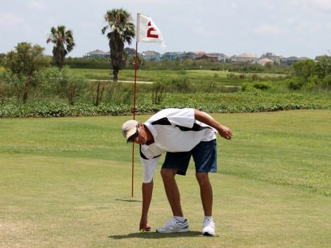 Brent Finch picking up his winning approach shot in the Third Place playoff. 