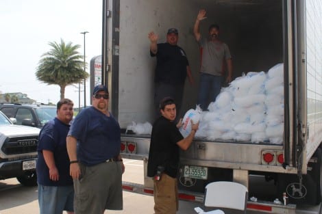 Volunteer Firemen from Coryell City, Turnerville, and Taylor VFDs came to Bolivar to help with the relief. Here they are distributing ice to local residents.